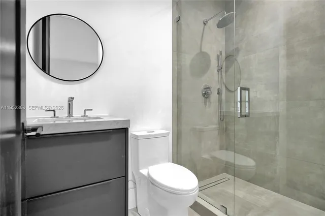 a bathroom with a toilet a sink and a mirror