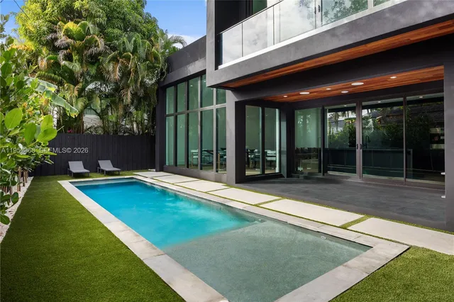 a view of a patio with a table and chairs under an umbrella