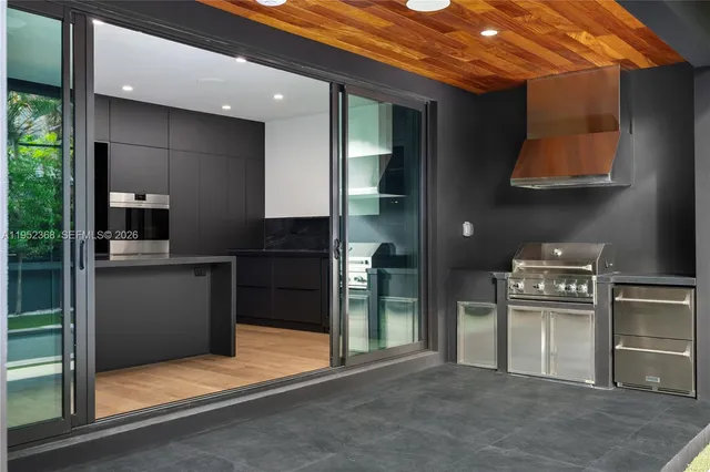 a kitchen with stainless steel appliances granite countertop a refrigerator and a stove