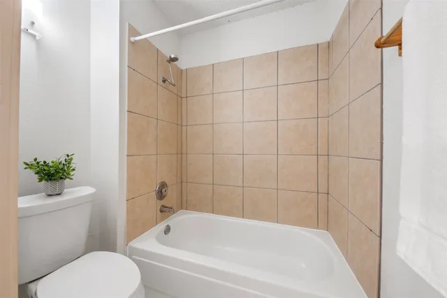 a white bath tub sitting next to a white toilet