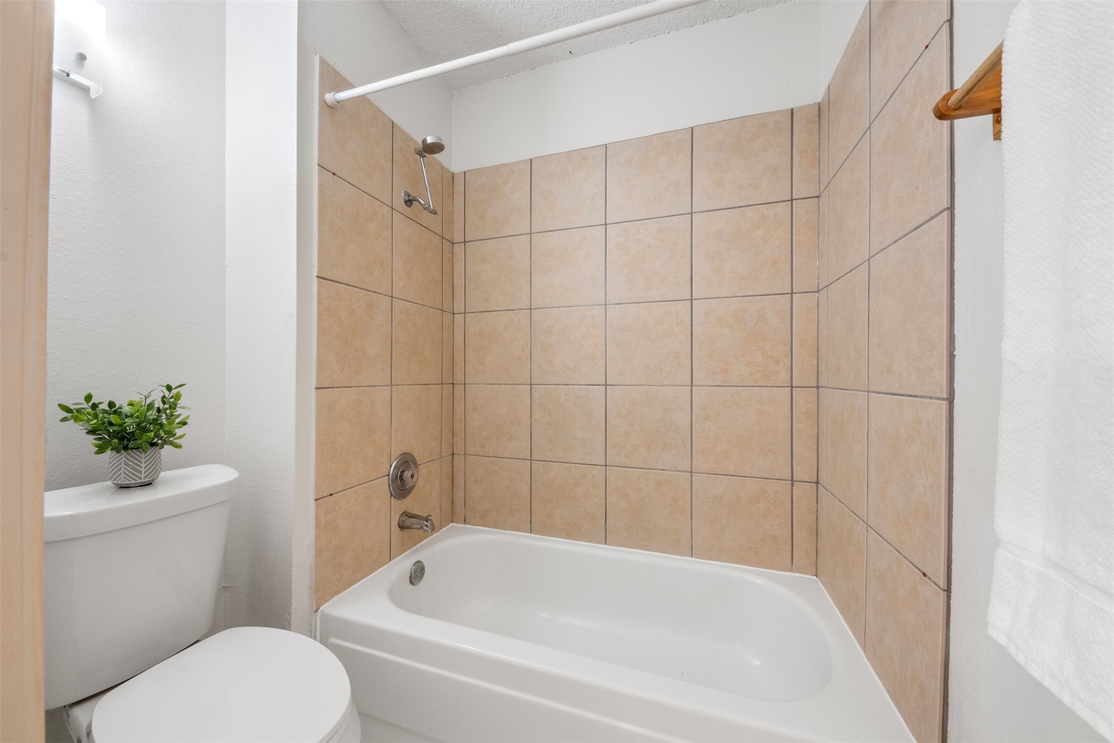 6701 Sands Point Drive, Unit 61 Houston, TX 77074 - Photo 12 of 20 a white bath tub sitting next to a white toilet