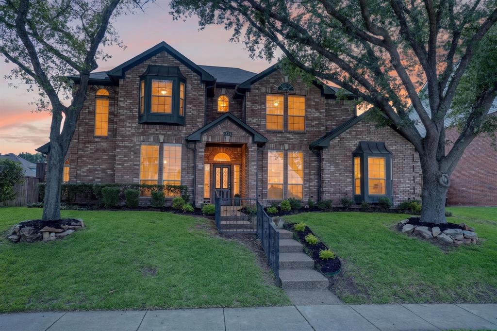 Brick exterior residence featuring a gabled roofline and multiple bay windows