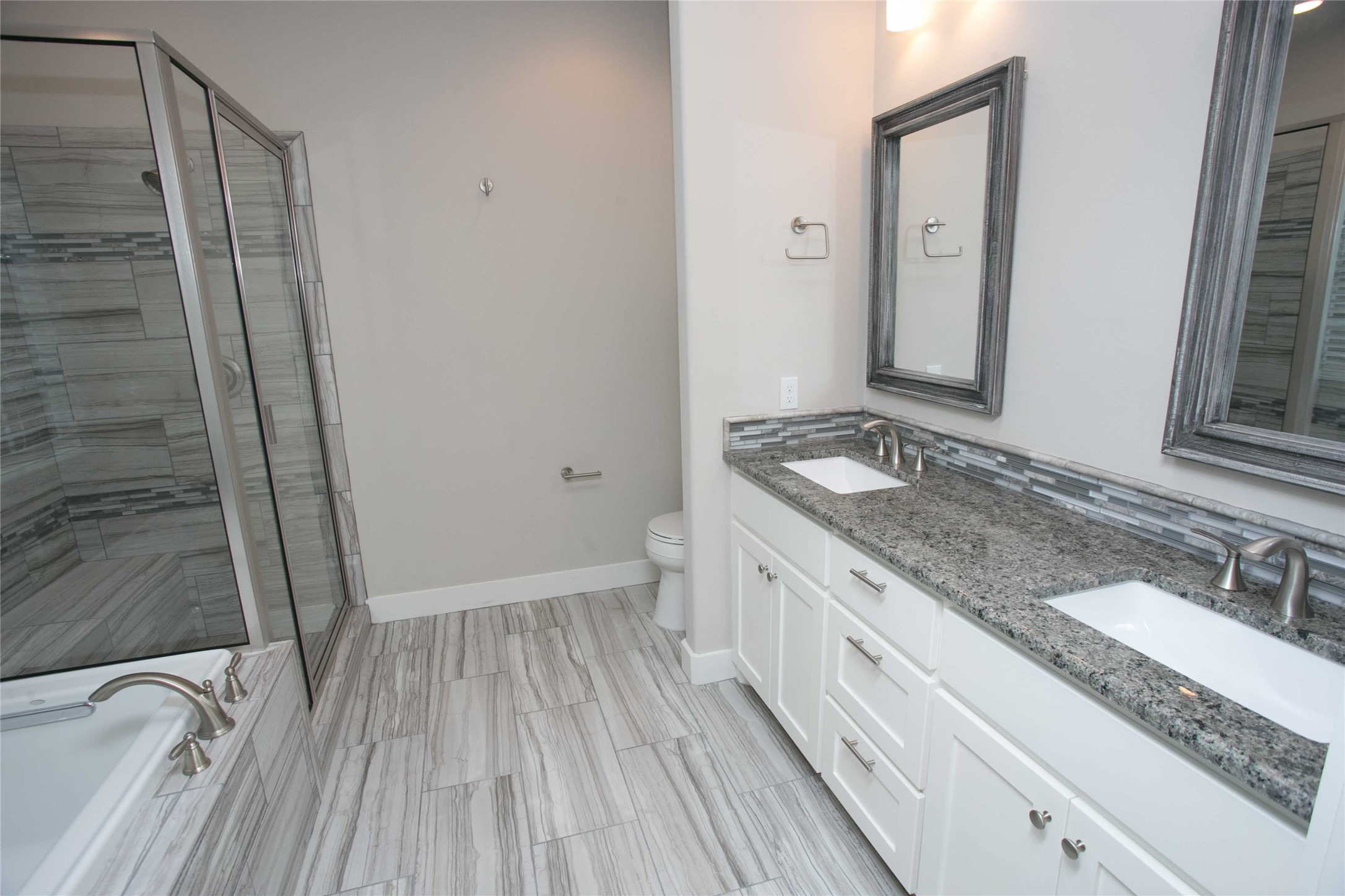 4301 Mansfield Dam Road, Unit 2102 Austin, TX 78734 - Photo 6 of 9 Luxurious primary bath with double vanity, granite counters, and a spacious shower.