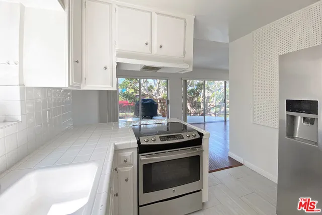 a kitchen with granite countertop a stove and a refrigerator