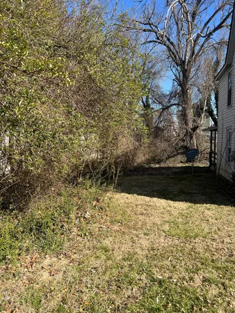 a view of yard with wooden fence