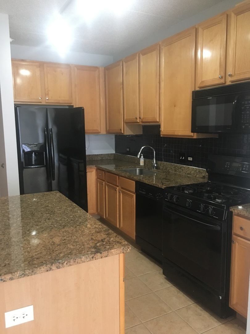515 Main Street, Unit 608 Evanston, IL 60202 - Photo 8 of 21 a kitchen with stainless steel appliances granite countertop a sink stove and refrigerator