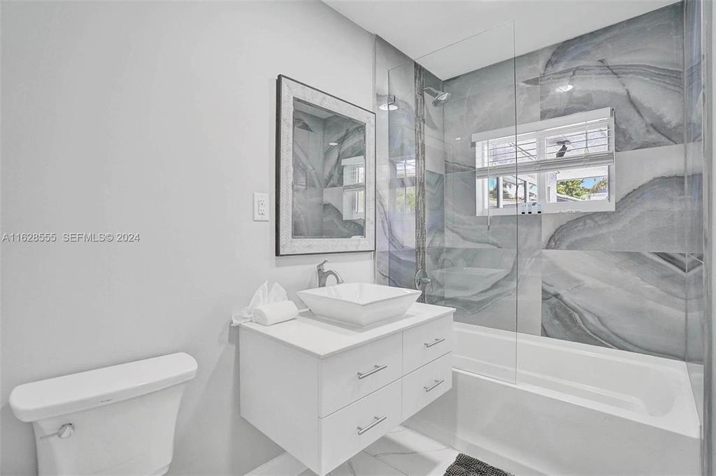3421 Dover Road Pompano Beach, FL 33062 - Photo 15 of 22 a bathroom with a sink a toilet and shower