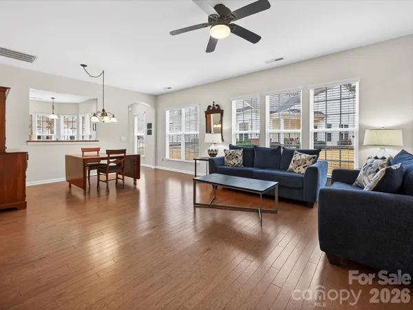 a living room with furniture and wooden floor
