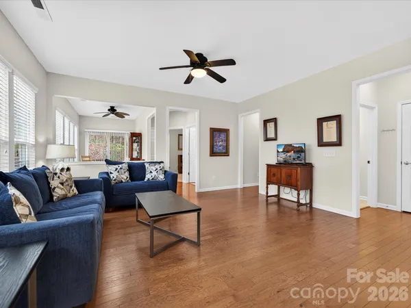 a living room with furniture and a wooden floor