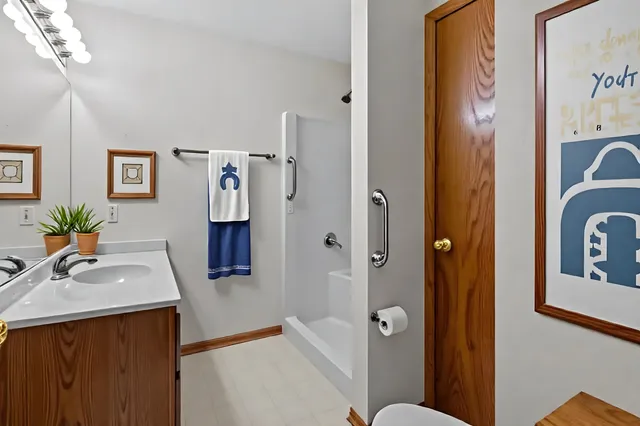 a bathroom with a sink a mirror and a shower