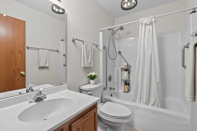 a bathroom with a sink toilet a mirror and shower