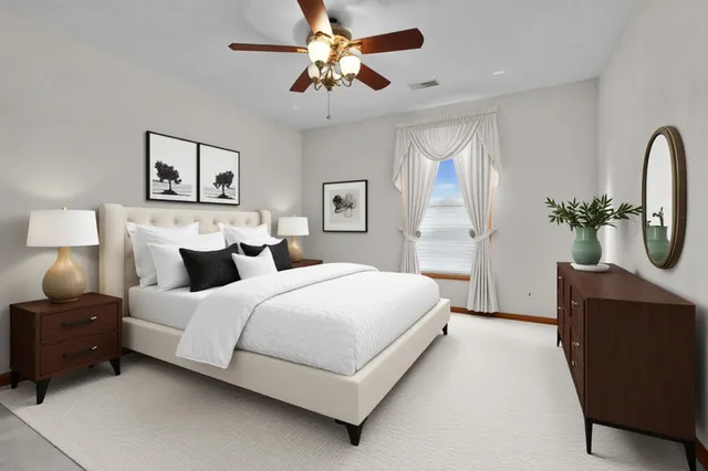 a spacious bedroom with a bed and a chandelier