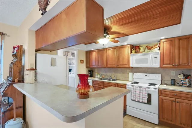 a kitchen with stainless steel appliances granite countertop a sink a stove and a refrigerator