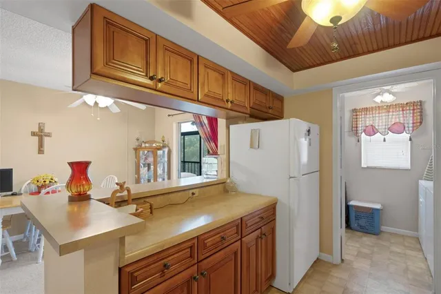 a kitchen with a refrigerator and a stove