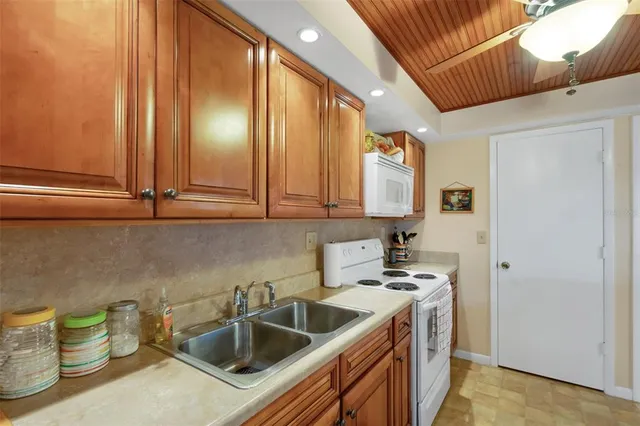 a kitchen with stainless steel appliances a sink a stove and a refrigerator