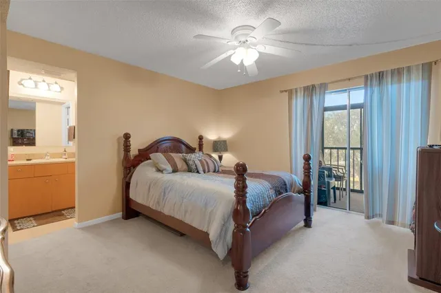 a spacious bedroom with a bed and a chandelier