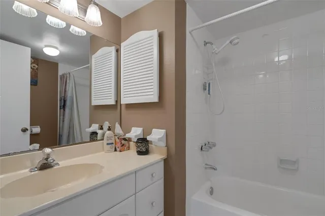 a bathroom with a sink a tub and a mirror