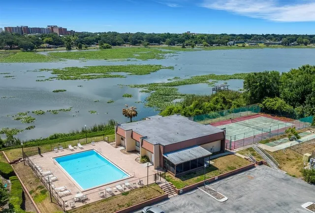 an aerial view of a house with a garden and lake view