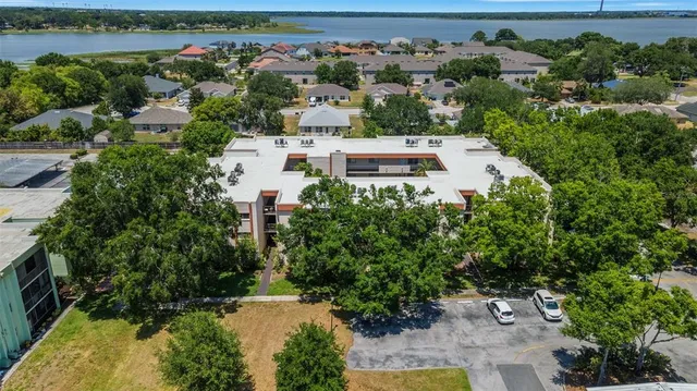 an aerial view of a house with a yard and lake view