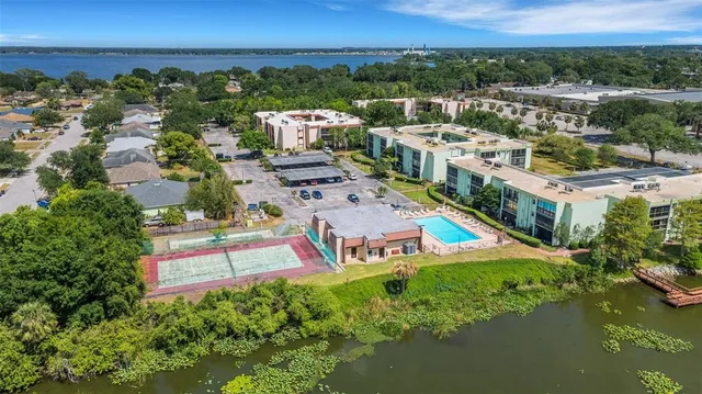 an aerial view of a house with a garden and lake view