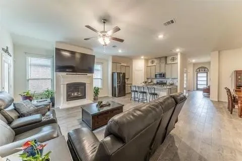 a living room with furniture a flat screen tv and a fireplace