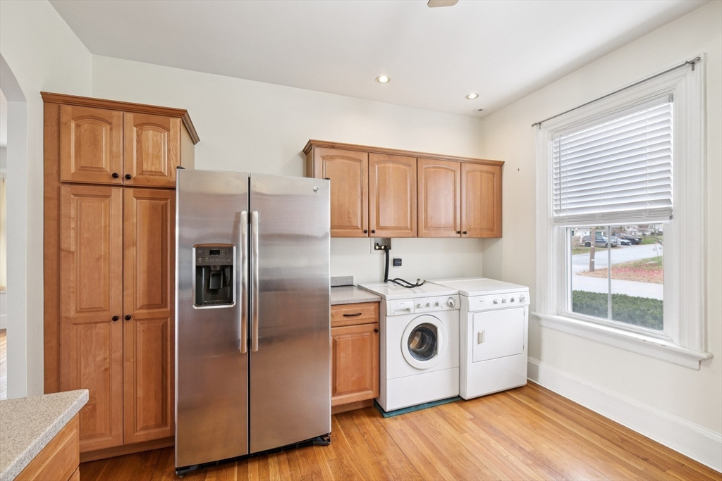2396 Riverside Avenue Somerset, MA 02726 - Photo 23 of 42 a kitchen with stainless steel appliances granite countertop a refrigerator a sink and a stove with wooden floors