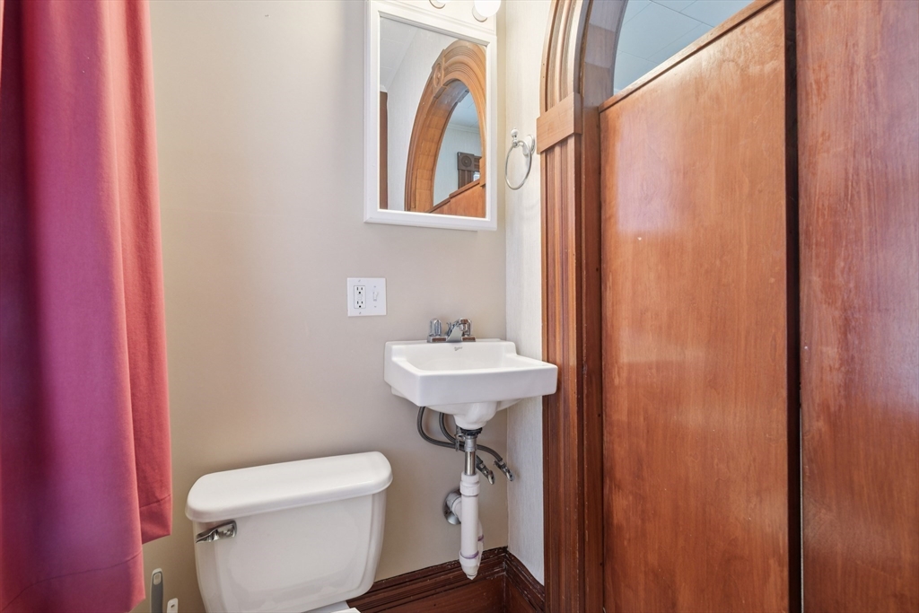 2396 Riverside Avenue Somerset, MA 02726 - Photo 32 of 42 a bathroom with a sink a mirror and a toilet