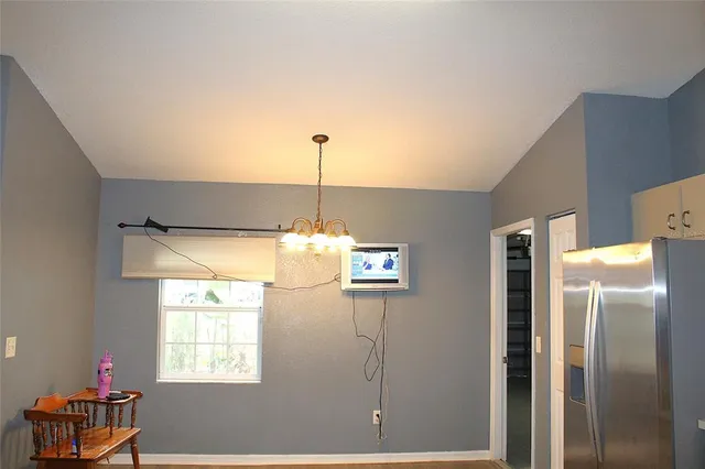 a view of a kitchen with a refrigerator cabinet and a window