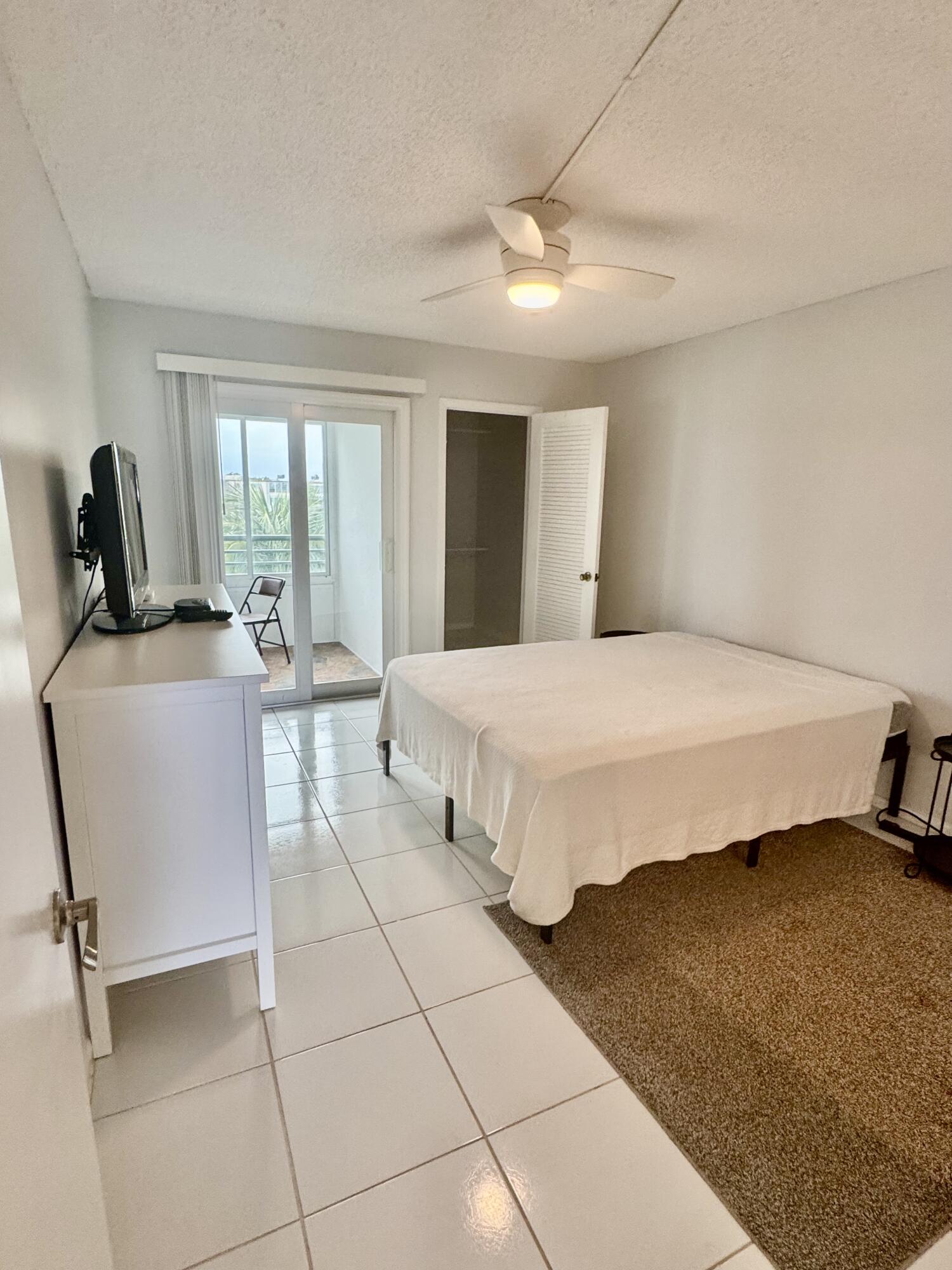 4063 Yarmouth C Boca Raton, FL 33434 - Photo 4 of 27 a bedroom with a bed and wooden floor