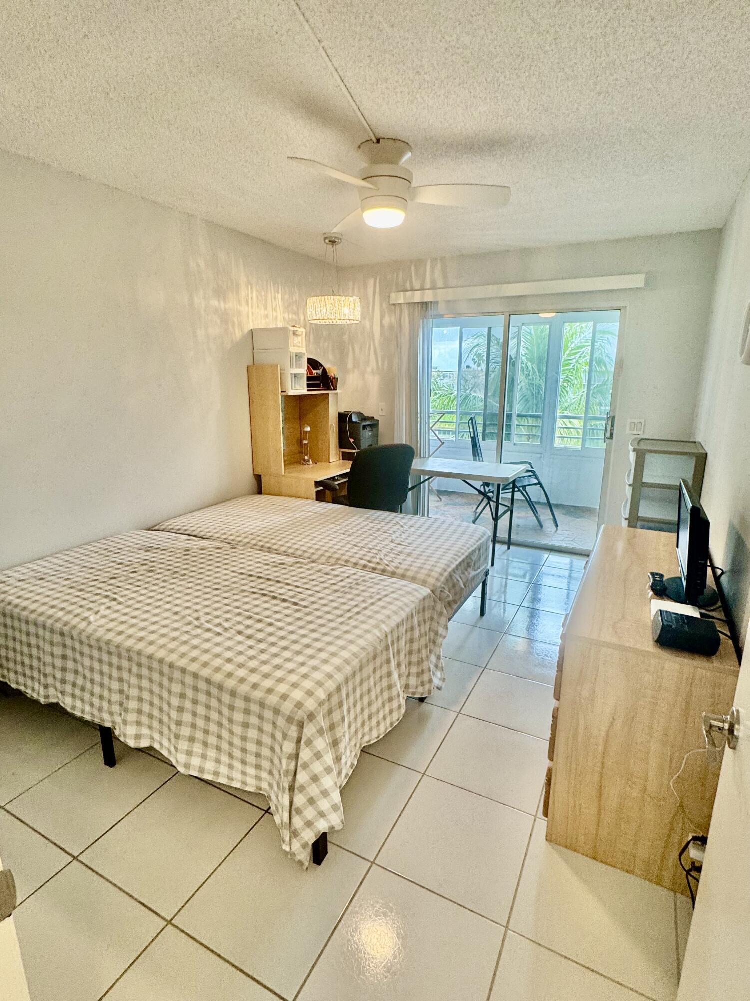 4063 Yarmouth C Boca Raton, FL 33434 - Photo 7 of 27 a bed room with a bed and a large window