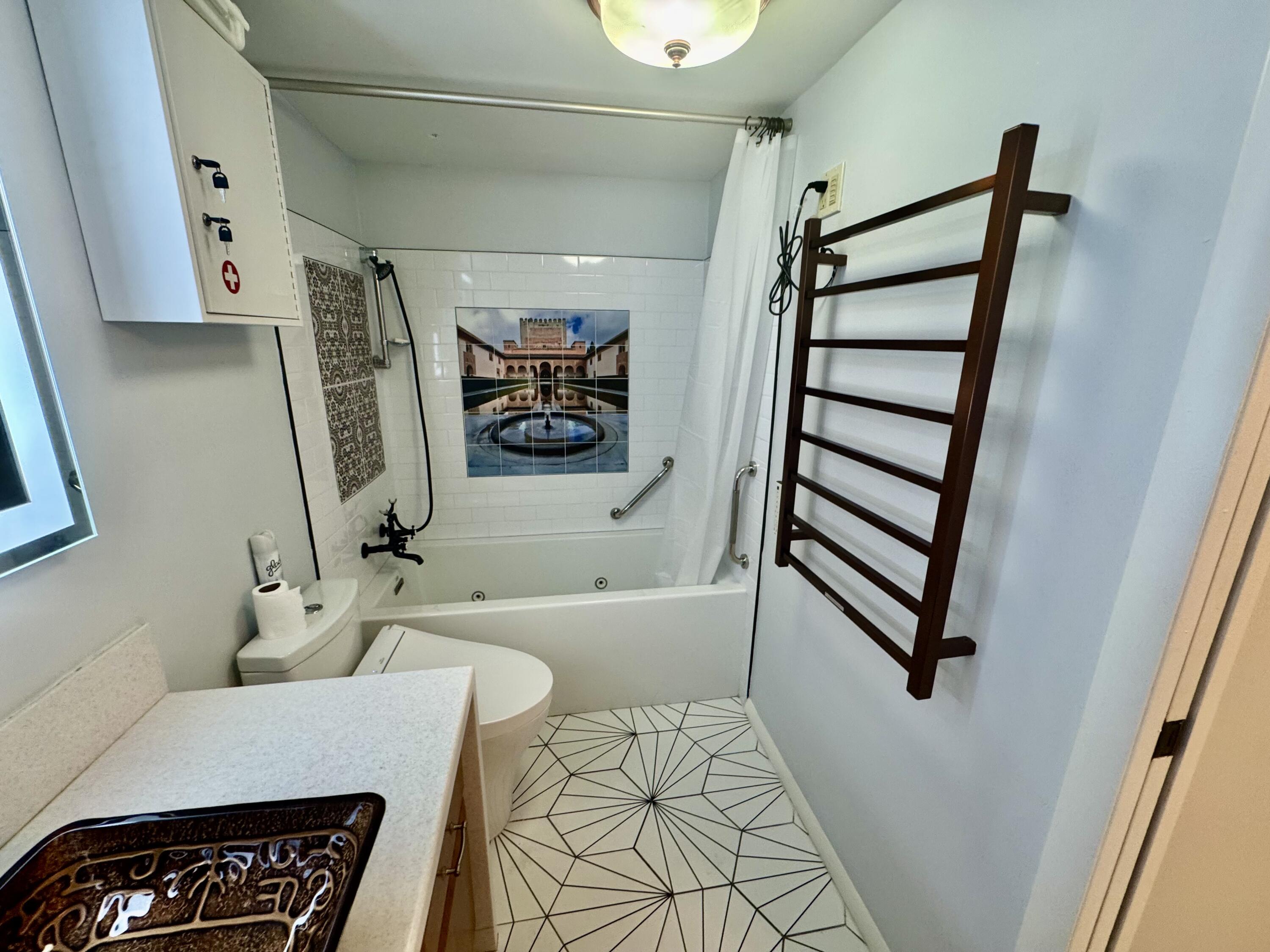 4063 Yarmouth C Boca Raton, FL 33434 - Photo 9 of 27 a bathroom with a bathtub and a shower
