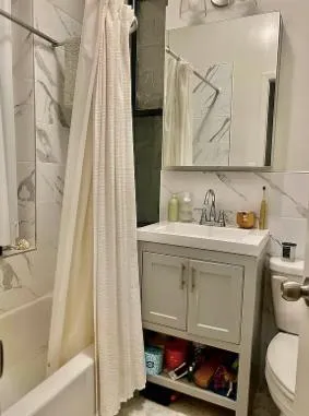 a bathroom with a sink toilet and tub