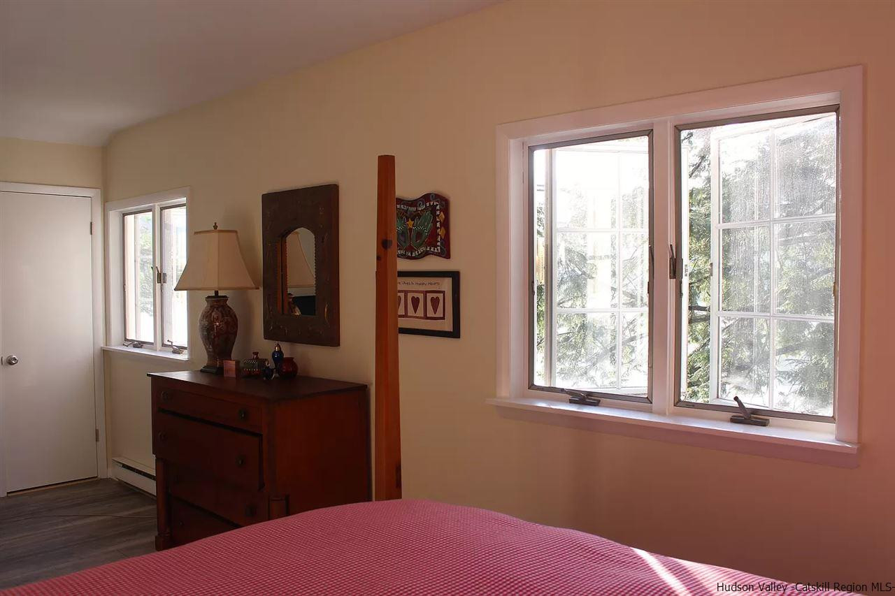 379 Tanglewood Lane Road Delhi, NY 13752 - Photo 23 of 35 a bedroom with a bed window and mirror