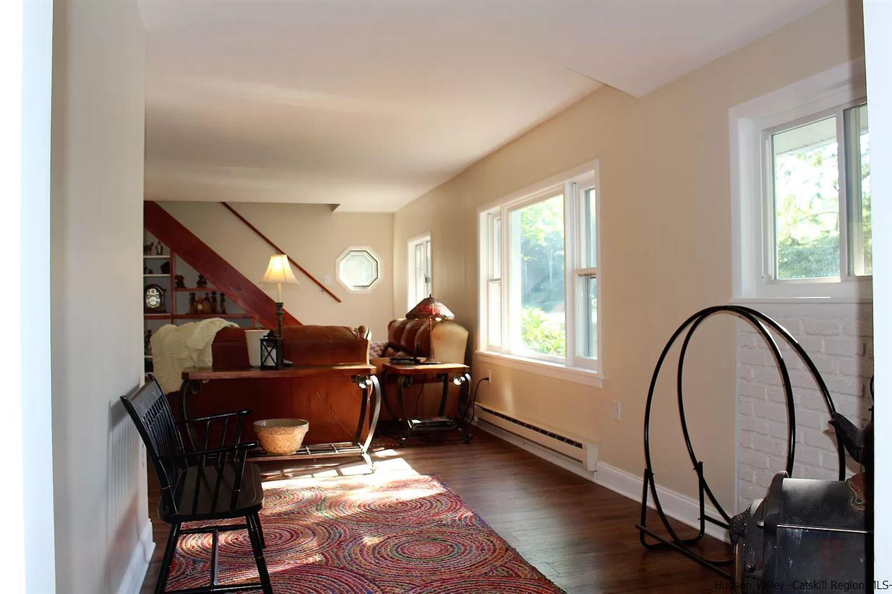 379 Tanglewood Lane Road Delhi, NY 13752 - Photo 3 of 35 a living room with furniture a dining table and a large window