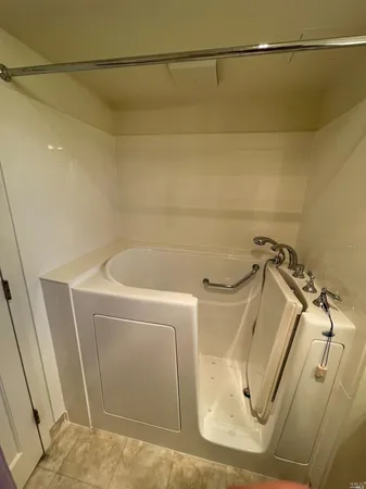 a view of a big room with closet and chandelier fan