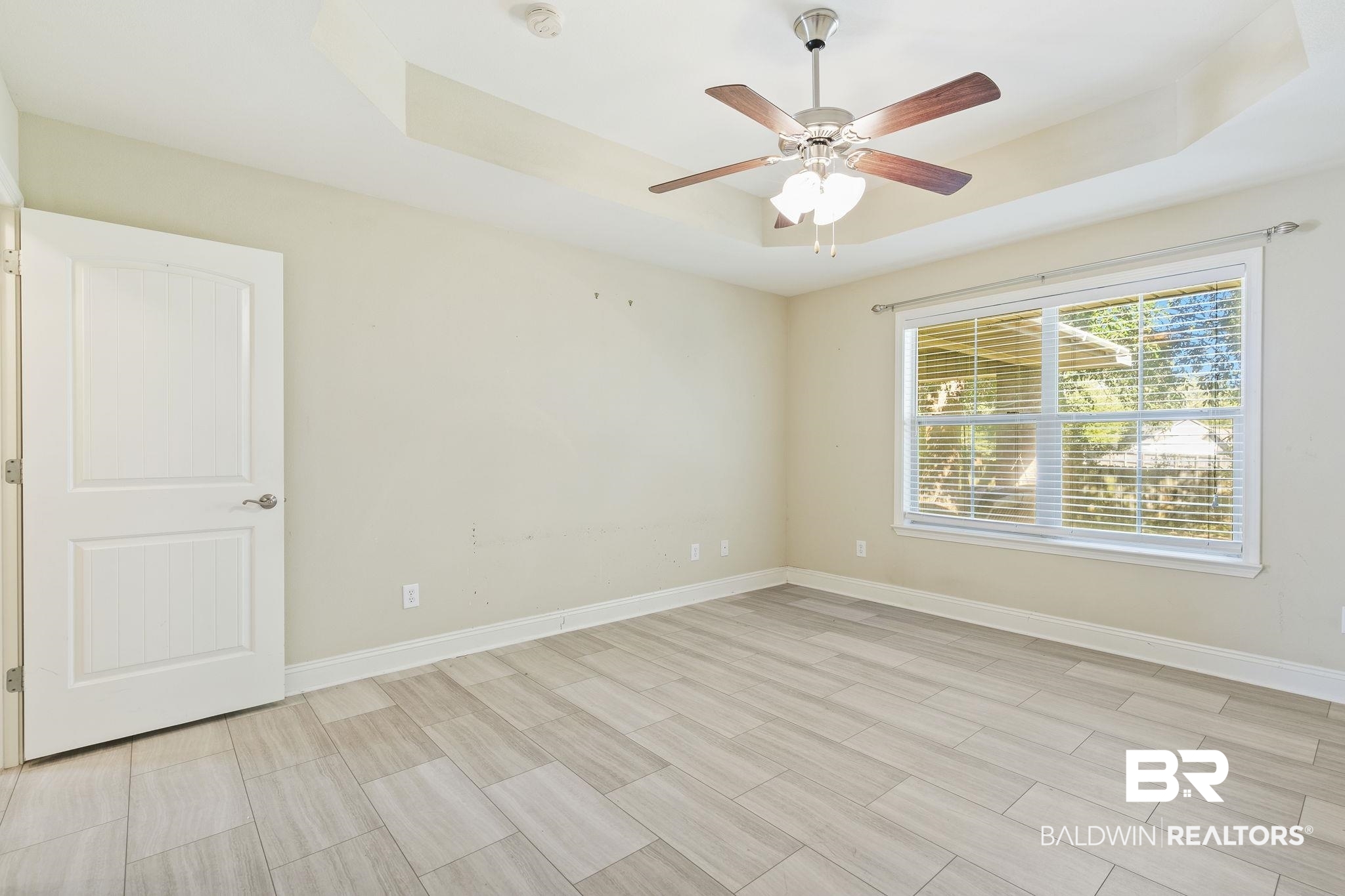 11153 Sturbridge Loop Daphne, AL 36526 - Photo 42 of 79 Empty room featuring a tray ceiling and ceiling fan