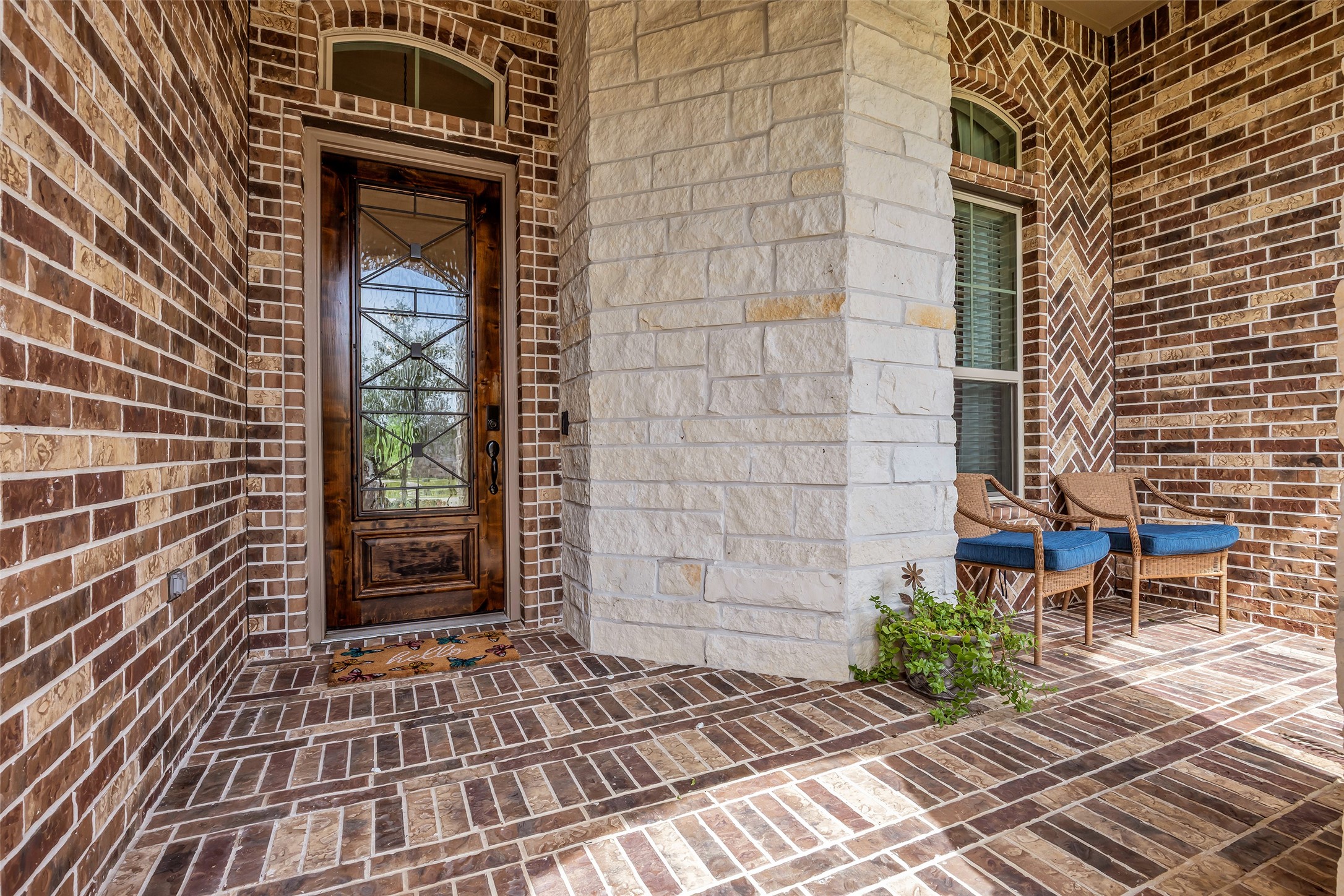 14003 South Evergreen Ridge Court Conroe, TX 77384 - Photo 4 of 43 Welcoming covered front porch showcases Texas limestone accents, a custom front door, and a comfortable sitting area.