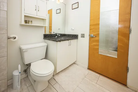 a bathroom with a toilet and a shower