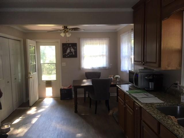 549 Blue Ridge Drive Blue Ridge, VA 24064 - Photo 6 of 22 a kitchen with granite countertop a stove dining table chairs and a refrigerator