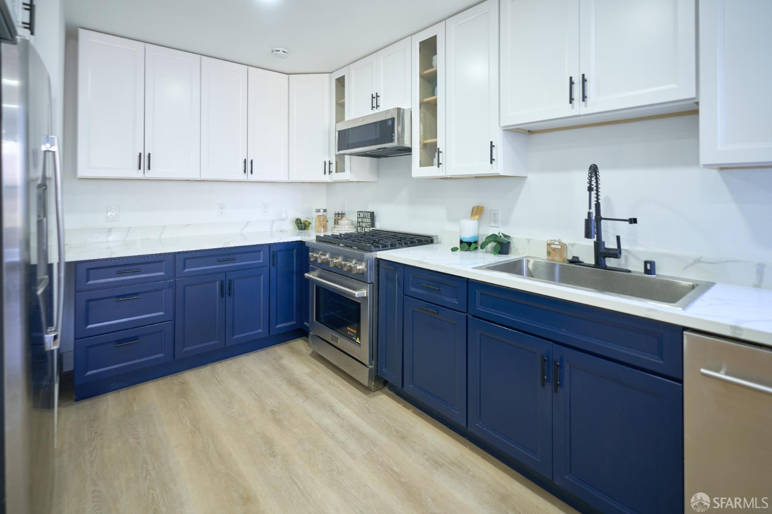 1270 South Van Ness Avenue, Unit A San Francisco, CA 94110 - Photo 11 of 28 a kitchen with stainless steel appliances granite countertop a sink and cabinets