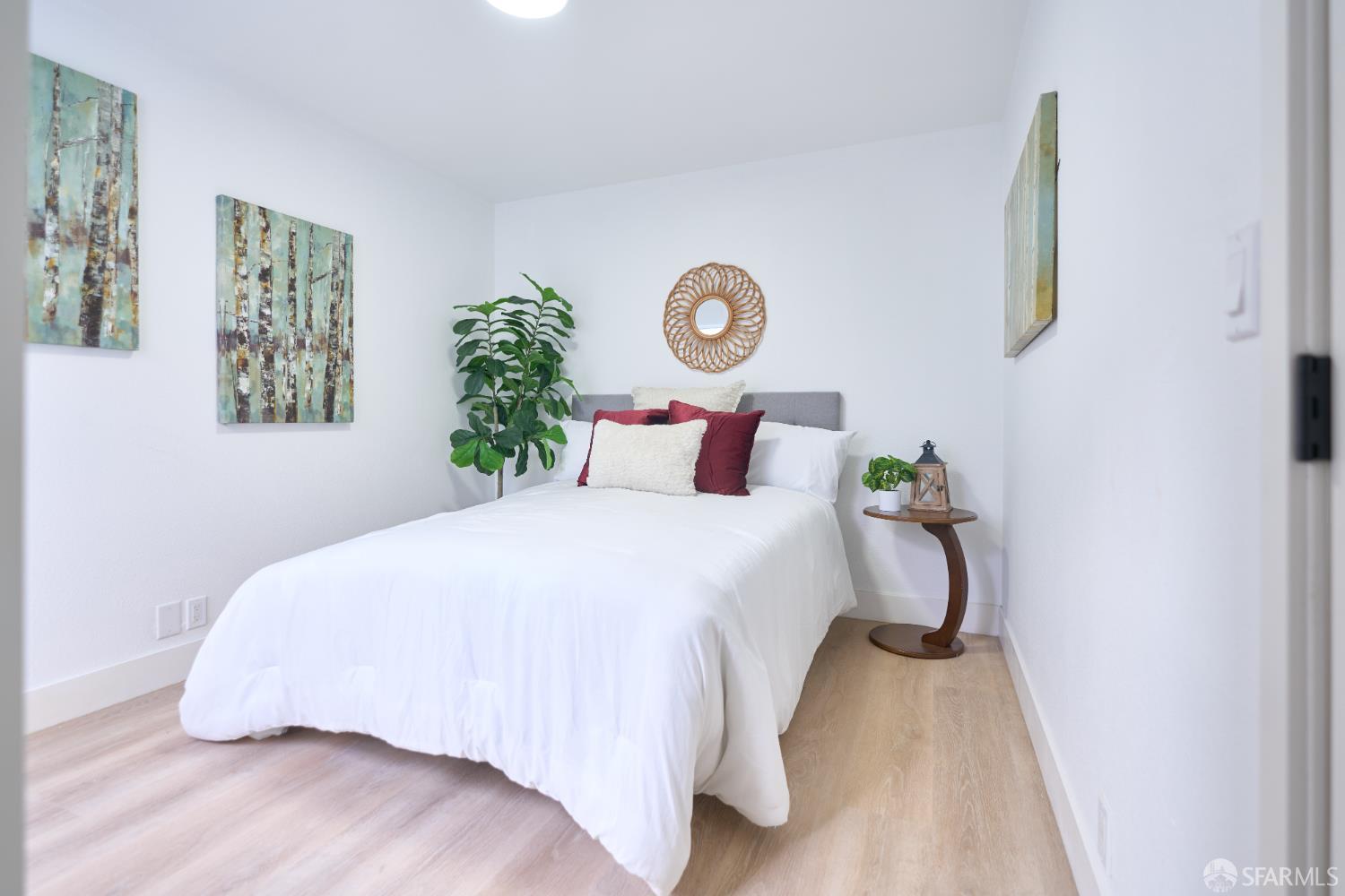 1270 South Van Ness Avenue, Unit A San Francisco, CA 94110 - Photo 19 of 28 a bedroom with a bed and painting on the wall