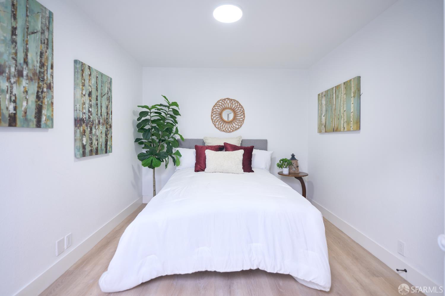 1270 South Van Ness Avenue, Unit A San Francisco, CA 94110 - Photo 20 of 28 a bedroom with a bed and a potted plant