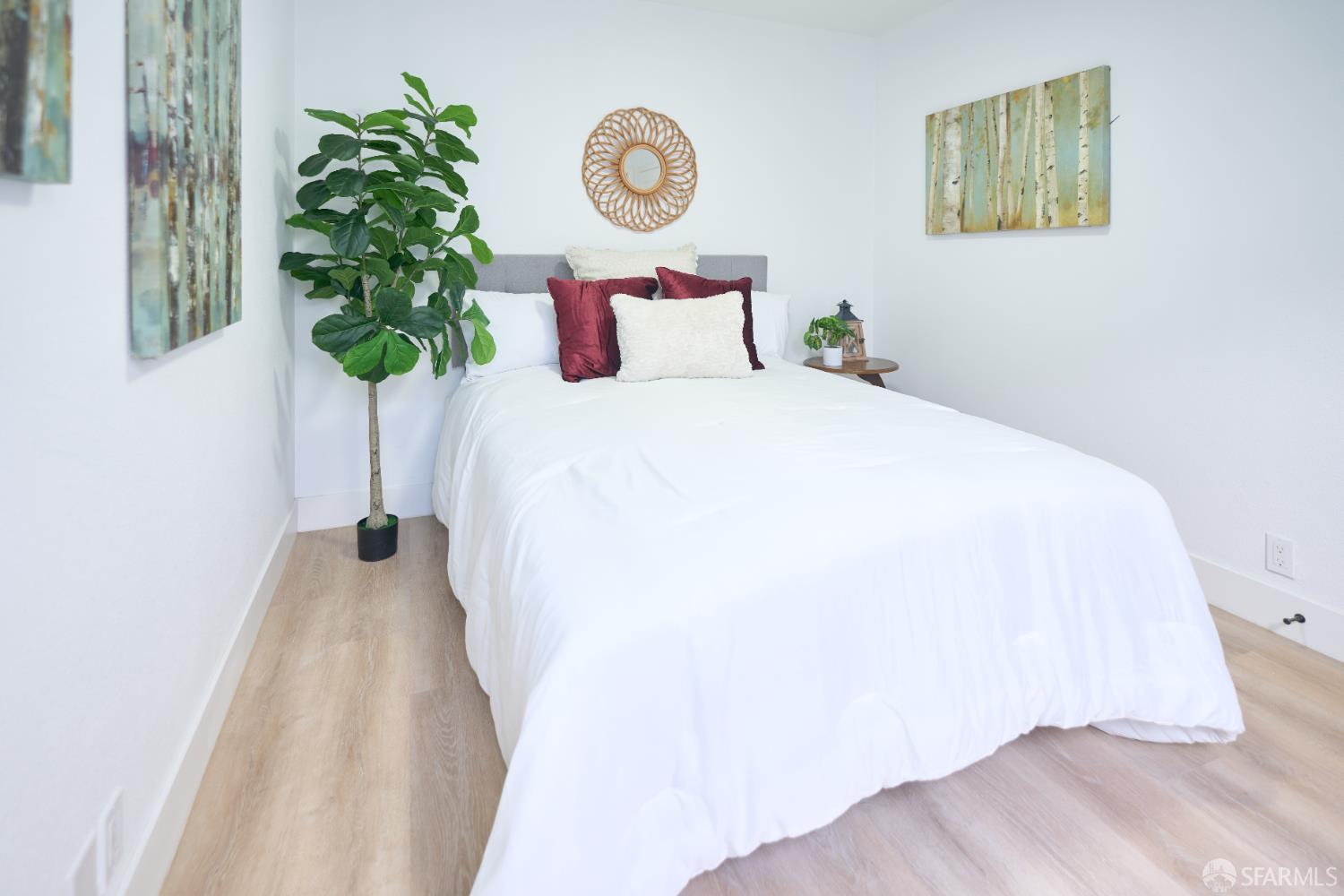 1270 South Van Ness Avenue, Unit A San Francisco, CA 94110 - Photo 21 of 28 a bedroom with a bed and a potted plant