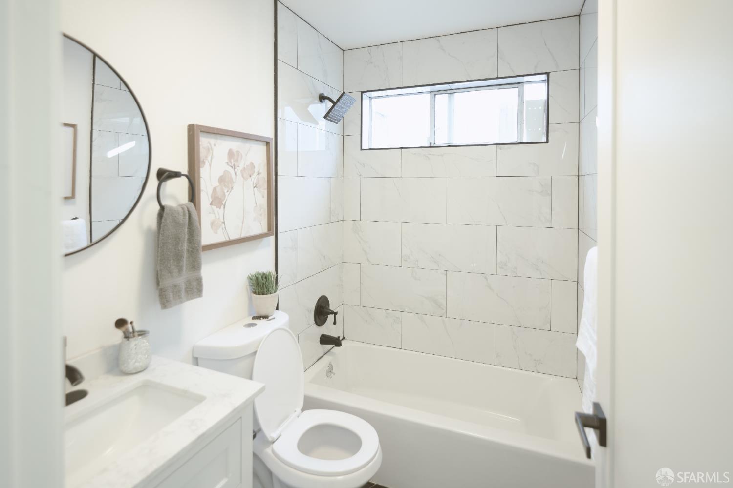 1270 South Van Ness Avenue, Unit A San Francisco, CA 94110 - Photo 23 of 28 a bathroom with a tub a sink and a mirror