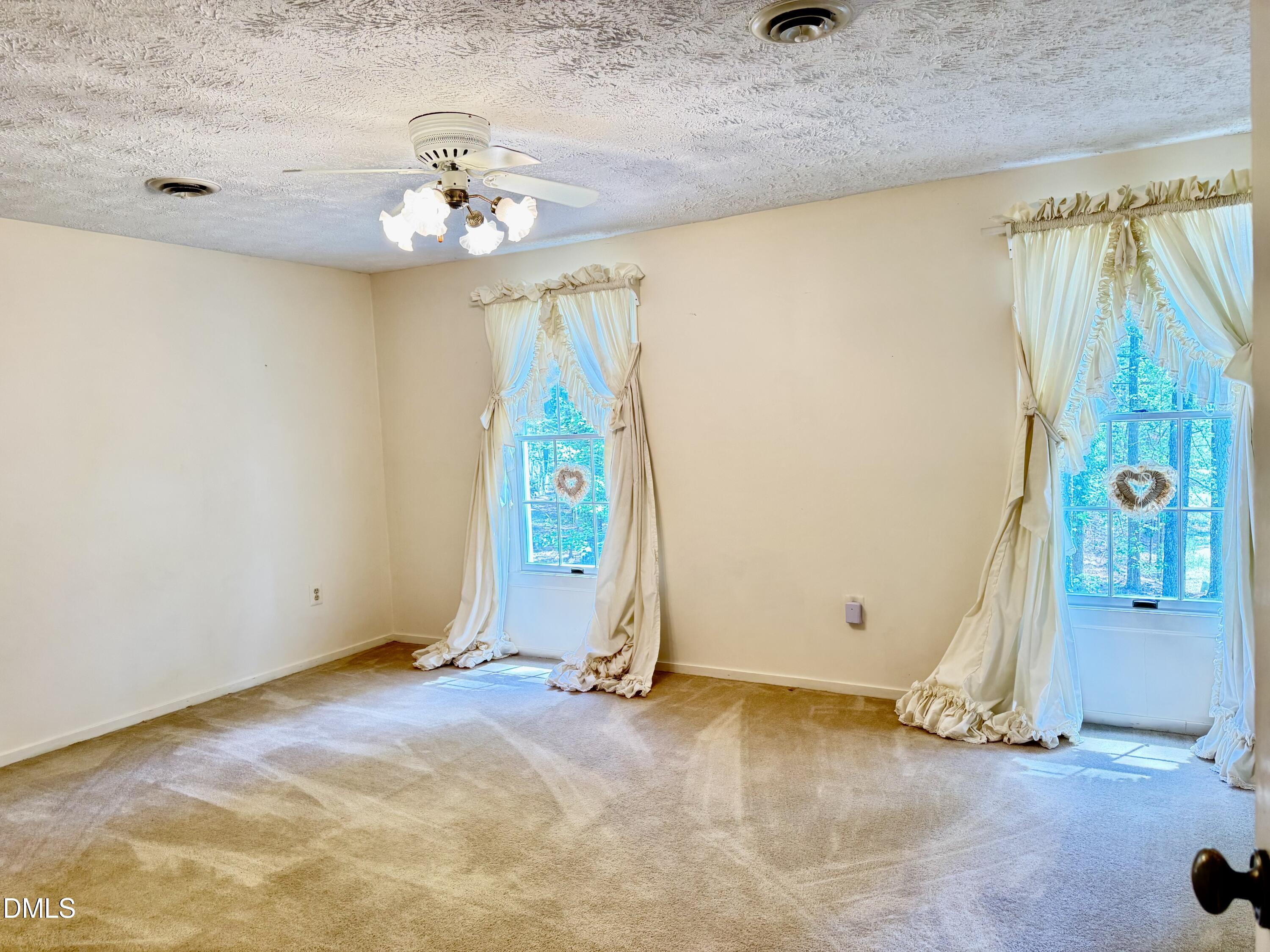 84 Wintergreen Road Henderson, NC 27537 - Photo 28 of 49 a view of a hallway with a chandelier