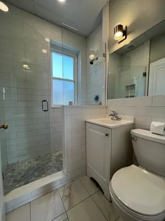 a bathroom with a sink toilet and shower