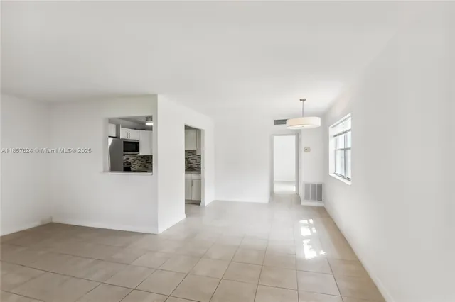 a kitchen with stainless steel appliances white cabinets and a stove