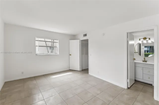 a large white kitchen with a large window