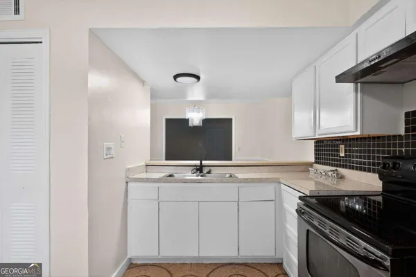 a kitchen with cabinets appliances and a sink