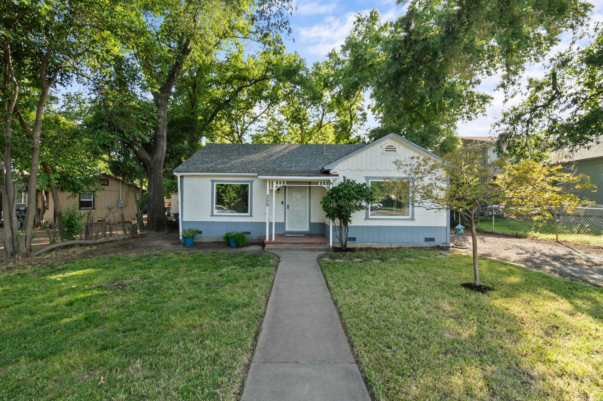 355 Jackson Street Red Bluff, CA 96080 - Photo 22 of 24 a front view of a house with a yard and trees